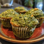 Close-up view of savory mini muffins with green beans and pesto.