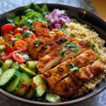 Close-up photo of Moroccan Chicken Couscous Bowl with vibrant ingredients.