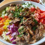 A close-up side view of a juicy Döner Bowl featuring diced chicken, fresh vegetables, and creamy yogurt.